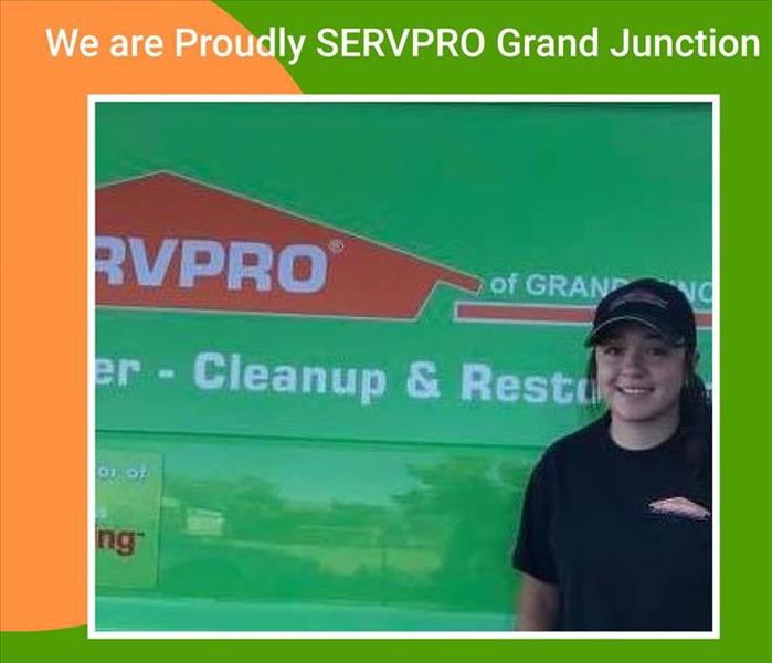 girl in cap on front of a SERVPRO truck